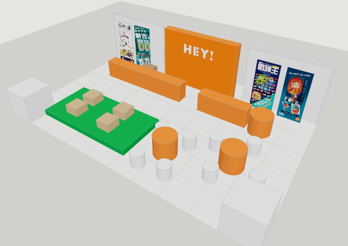 上から見た HEY! のブース。奥に販売の長机、手前に試遊の丸テーブル、左手に畳のスペース